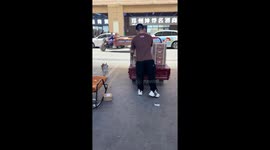 Delivery dog rides atop loaded tricycle in Henan, China