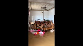 Chickens take refuge on table during flood in Guangdong, China