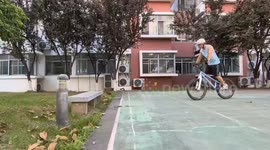 Cyclist fails wheelie trick and lands on bench in Jiangsu, China