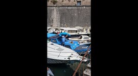 Owner sets up umbrella for lounging dog on boat in Zadar, Croatia