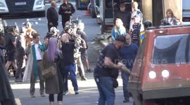 Glen Powell chases a purple haired jenna ortega in Glasgow, Scotland, UK