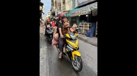 Dog Rides Scooter with Owners in Heartwarming Street Scene in Vietnam