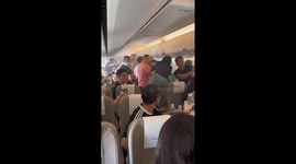 Passengers use bottles of water as smoke seen at the end of plane