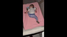 Baby sleeping soundly in funny position in New York, USA