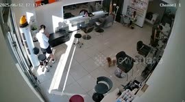 Barber's shocking surprise as he repairs plugged-in hairdryer
