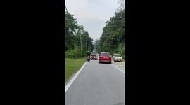 Trailer bounces along road while being pulled by car