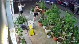 Shopkeeper battles to protect his plants during storm in China