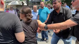 Woman Shouts ‘Murderer’ at Greek Prime Minister Mitsotakis During Public Address
