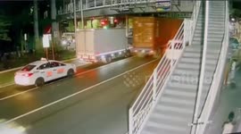 Trailer container falls onto taxi at low overpass in Manila, Philippines