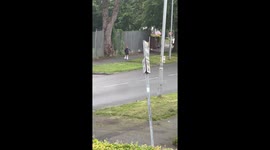 Little girl struggles on roller skates with patient help in Manchester, England, UK