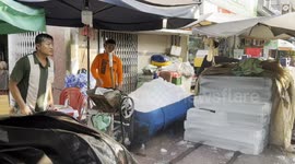Ice block crushing at sunrise – Street scene in Ho Chi Minh City
