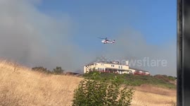 Helicopters dump water on Ranch Place Fire threatening homes in California