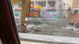 Digger operator flips debris like a chef using a wok