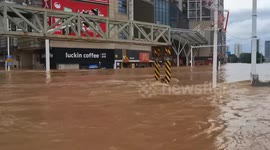Rescue teams in boats traverse flooded streets in China
