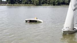 dingy capsizes then gets helped back up on Thames