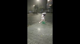 Woman catches fish during street flooding in Guangdong, China