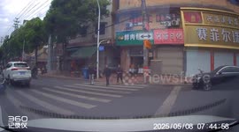 Man bows to drivers before crossing street in Anhui, China