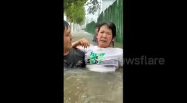 Sales team rescue woman trapped inside flooded car in heroic footage