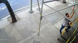 Scaffolding collapses inches from man taking pictures