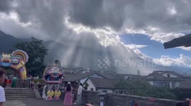 Sun rays cascade through clouds at beauty spot in China