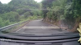 Tricycle tilts onto its side while taking sharp mountain turn