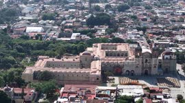 Oaxaca de Juárez, a city in central Mexico, features colonial buildings, many of which are in the Zócalo, the central square, and the Government Palace, with colorful murals depicting regional history. The Alameda de León square faces the ornate facade of