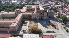 Oaxaca de Juárez, a city in central Mexico, features colonial buildings, many of which are in the Zócalo, the central square, and the Government Palace, with colorful murals depicting regional history. The Alameda de León square faces the ornate facade of