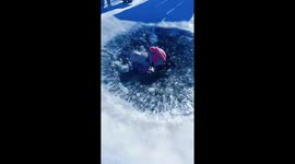 Woman tries to climb out of a freezing pit but slips on the slick ice
