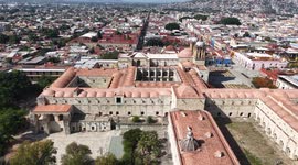 Oaxaca de Juárez, a city in central Mexico, features colonial buildings, many of which are in the Zócalo, the central square, and the Government Palace, with colorful murals depicting regional history. The Alameda de León square faces the ornate facade of