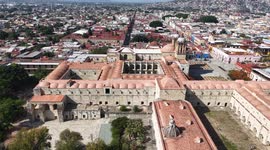 Oaxaca de Juárez, a city in central Mexico, features colonial buildings, many of which are in the Zócalo, the central square, and the Government Palace, with colorful murals depicting regional history. The Alameda de León square faces the ornate facade of