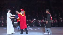 Student lifts and spins university president at graduation ceremony