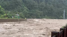 Heavy mountain runoff turns river into raging rapids in China