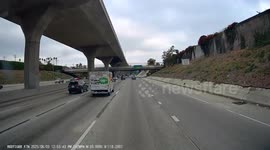Person Throws a Large Rock on the Freeway