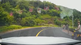 Tricycle narrowly avoids collision with passing car