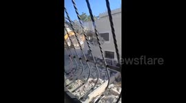 Israeli bulldozers are demolishing a two-storey
