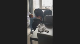 Toddler Feeds Chocolate Mousse to a Baby