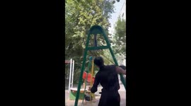 Boy spins midair on strong swing ride in Almaty, Kazakhstan