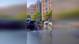 Children cool off in water hydrants in New York