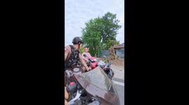 Kind policemen hand out helmets to locals caught break law
