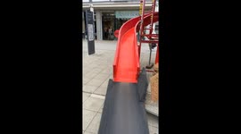 Little boy goes down slide and accidentally knocks over girl at the park