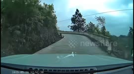 Motorcycle mishap on curve road in Guangxi, China