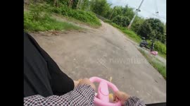 Woman falls from steering toy wheel in Guangxi, China