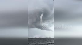 Spectacular twin waterspouts seen from boat in Florida