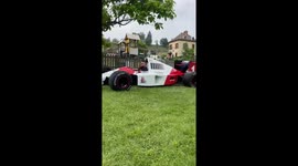 Motorsport fanatic drives his F1 car across front lawn