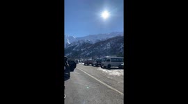 Friends enjoy food on a sunny day with snow alps in Maule, Chile