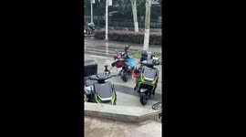 Electric motorcycle spins unexpectedly in parking area in Hubei, China
