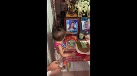 Heartbreaking moment toddler touches picture of late mother