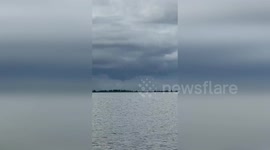 US: Twin Waterspouts Twist Over Ship Island As Spectators Watch In Shock