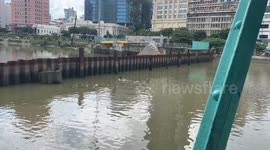 Man Retrieves Fishing Net for Dinner in Urban River – Ho Chi Minh City