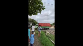 Hero locals push lorry stuck on level crossing as train approaches